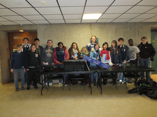 Members of the Oceanside High School robotics team are pictured displaying the contents of the kit of parts.