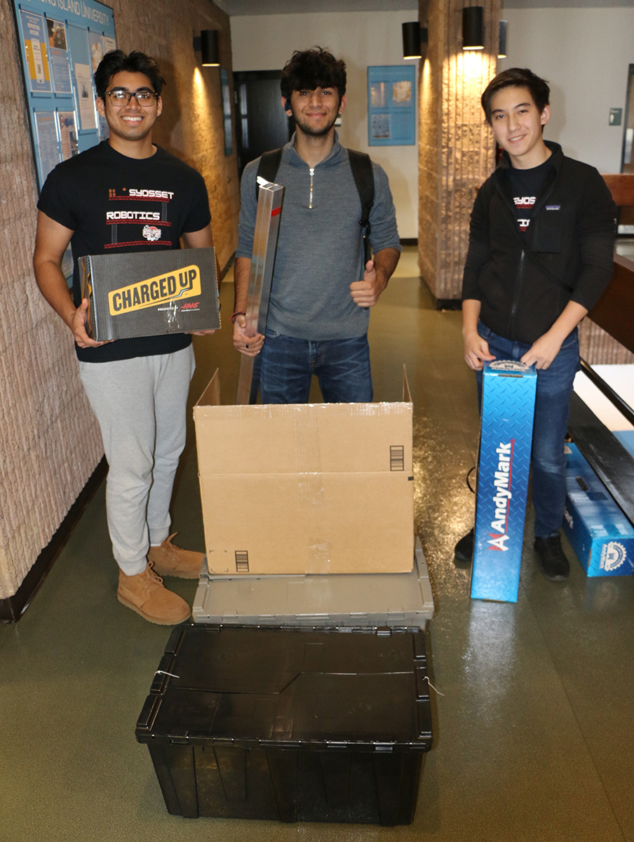 Members of the Syosset High School robotics team are pictured displaying the contents of the kit of parts. This is their first year competing in the FRC Long Island Regional.
